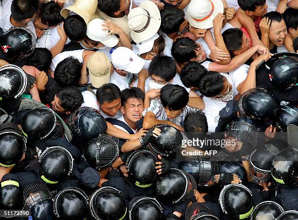 South Korean protesters clash with riot police during anti-war rally in downtown Seoul, 15 August 2004. About 6,000 activists rallied near the US...
