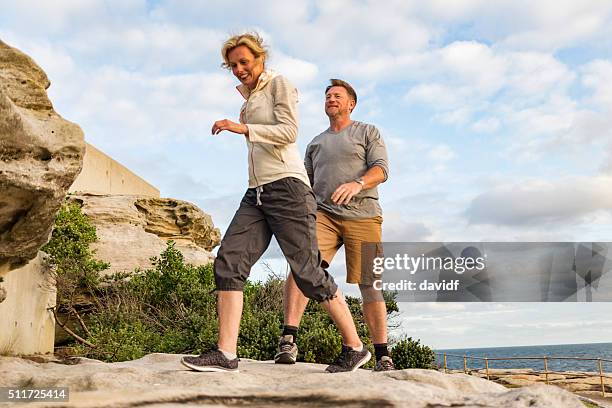 happy middle aged active fit healthy beach couple hiking outdoors - active lifestyle walking stock pictures, royalty-free photos & images