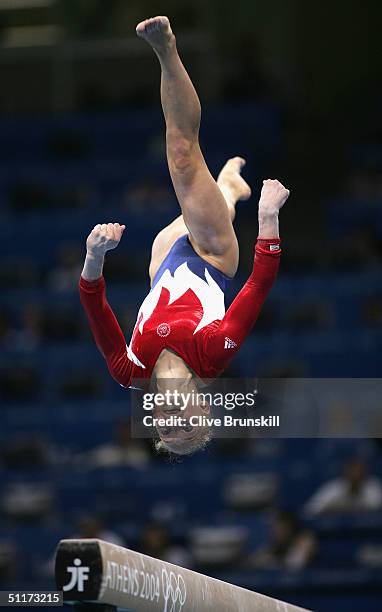 Courtney McCool of the USA competes in the qualification round of the team event at the women's artistic gymnastics competition on August 15, 2004...