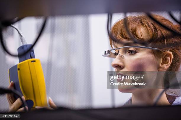 serious technician working on a server - smart glasses stock pictures, royalty-free photos & images