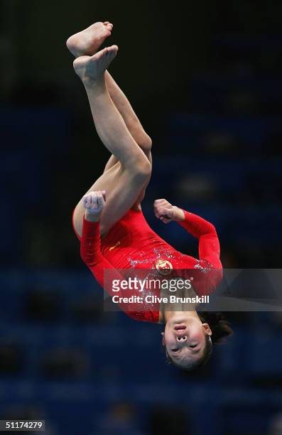 Fei Cheng of China competes in the qualification round of the team event at the women's artistic gymnastics competition on August 15, 2004 during the...