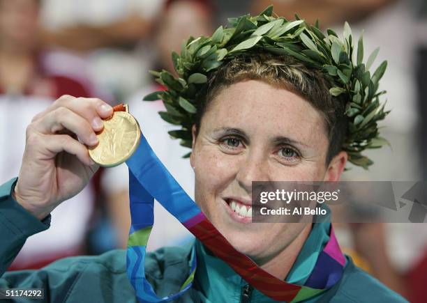 Gold medalist Petria Thomas of Australia holds her medal as she celebrate winning the women's swimming 100 metre butterfly event on August 15, 2004...