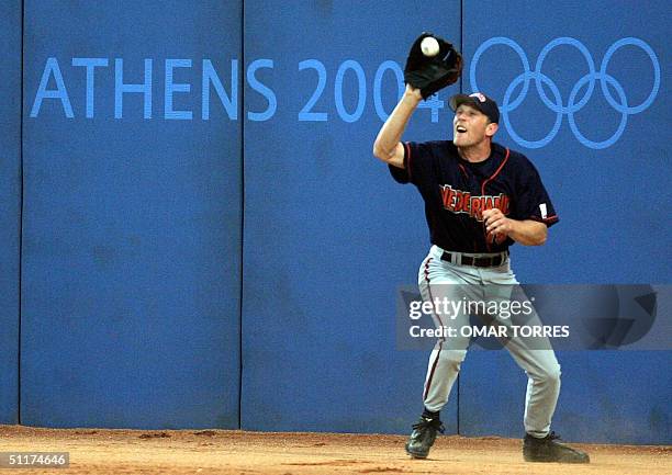 Netherlands right fielder Dirk van T'Klooster catchs a fly ball during the third inning of the preliminary round baseball game against Greece, 15...