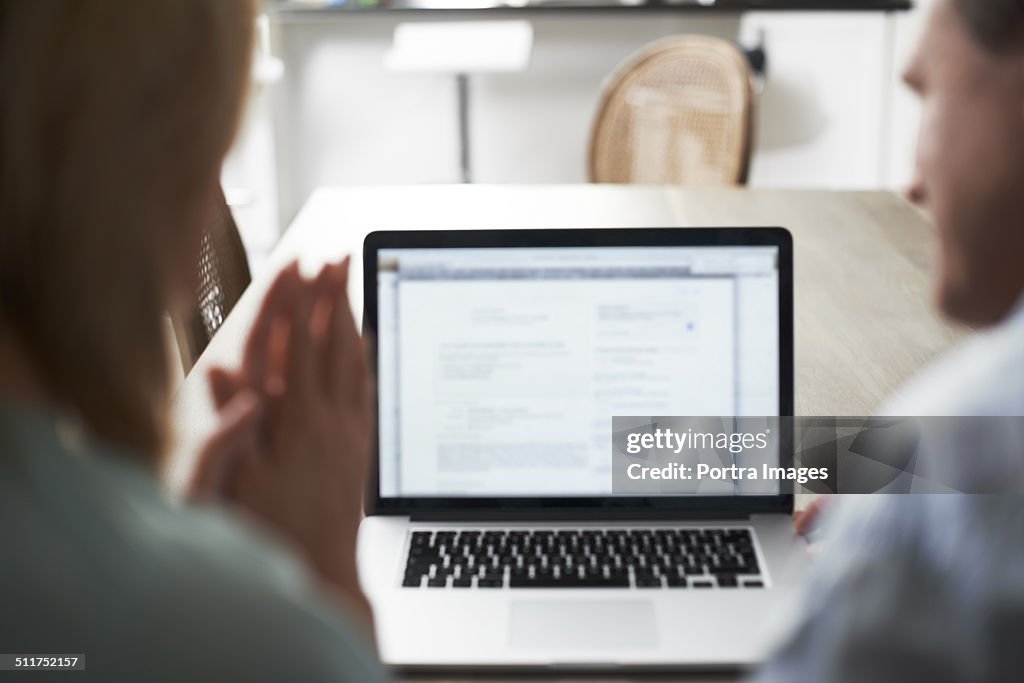 Couple social networking on laptop