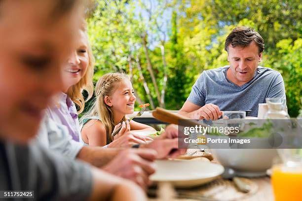 family having healthy breakfast at table - family four people stock pictures, royalty-free photos & images