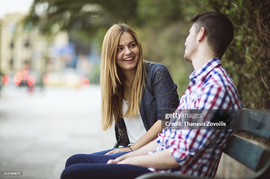Couple on park bench talking