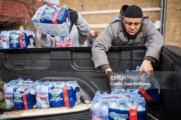 Volunteers load bottled water in a truck at the the Sylvester Broome Center in Flint, Mich., February 22, 2016. The center is being used for water...