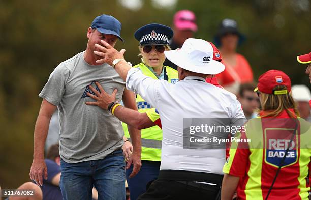 Security detain a spectator during day four of the Test match between New Zealand and Australia at Hagley Oval on February 23, 2016 in Christchurch,...