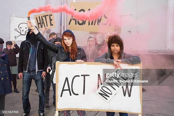 two female activists demonstrating with banners - march 22 2013 stock pictures, royalty-free photos & images