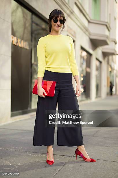 Becky Kriebel is seen on Oak Street wearing Ray Ban glasses, L.K. Bennett yellow sweater and black culottes pants, and red Patchwork shoes on...