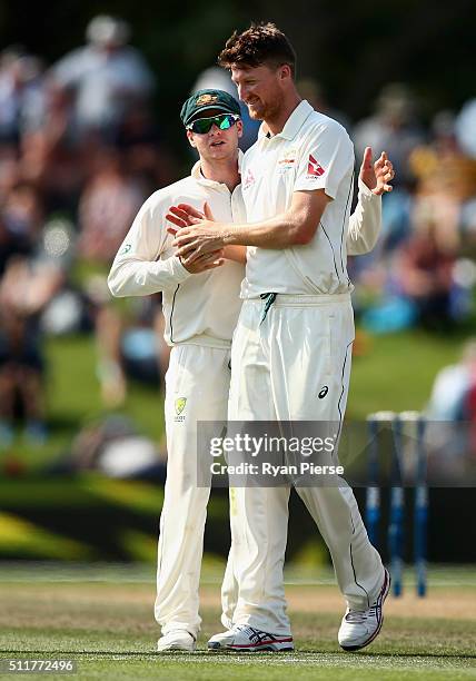 Jackson Bird of Australia is congratulated by Steve Smith of Australia after finishing with five wickets during day four of the Test match between...