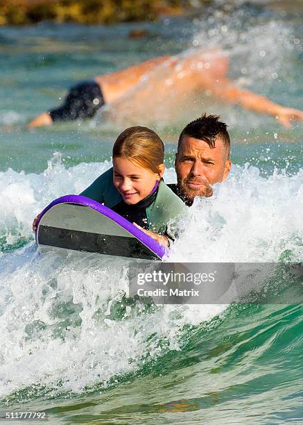 Celebrity chef, Pete Evans enjoys a surf at Bondi Beach with daughters Chilli and Indii on February 22, 2016 in Sydney, Australia.