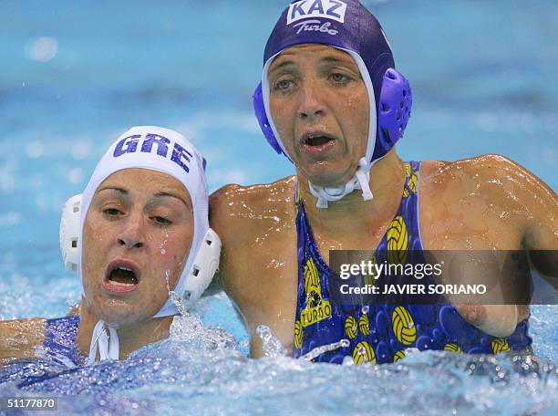 Greek Stravoula Kozompli vies Tatyana Gubina during their Olympic Games women's preliminary group B match against Kazakhstan 03, at the swimming...