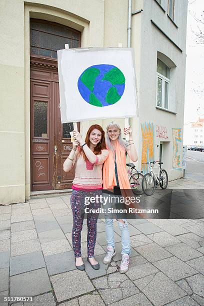 two female activists demonstrating with banner - march 22 2013 stock pictures, royalty-free photos & images