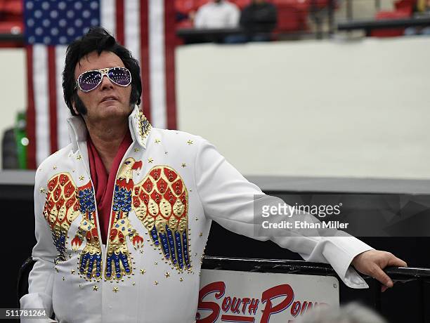 Paige Pool of Nevada, dressed as Elvis Presley, watches a video before a rally for Republican presidential candidate Donald Trump at the South Point...