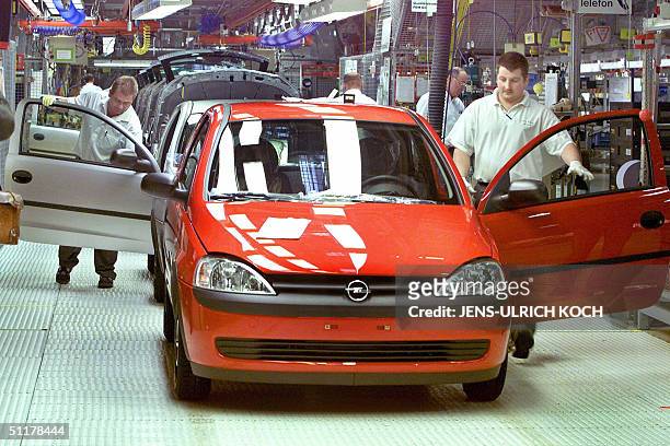 This picture taken on 19 January 2001 shows employees of German car maker Opel assembling a Corsa car at the company's plant in the eastern town of...