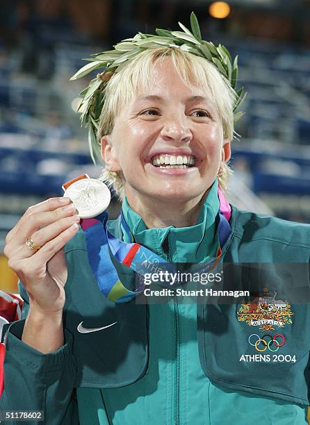 Silver medalist Brooke Hanson of Australia poses with her medal after the medal ceremony for the women's swimming 100 metre breaststroke event on...