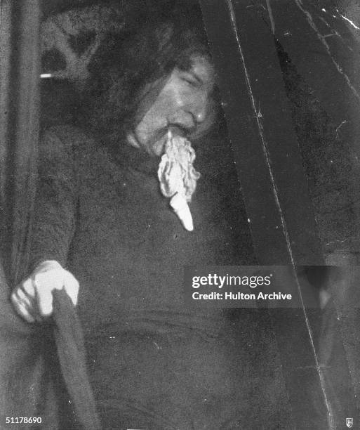 Strange substance, identified as ectoplasm, emerges from the mouth of medium Marthe Beraud during a seance, circa 1910. Picture taken from 'Les...