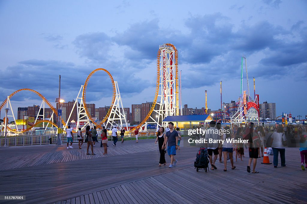 People on boardwalk near new roller coaster