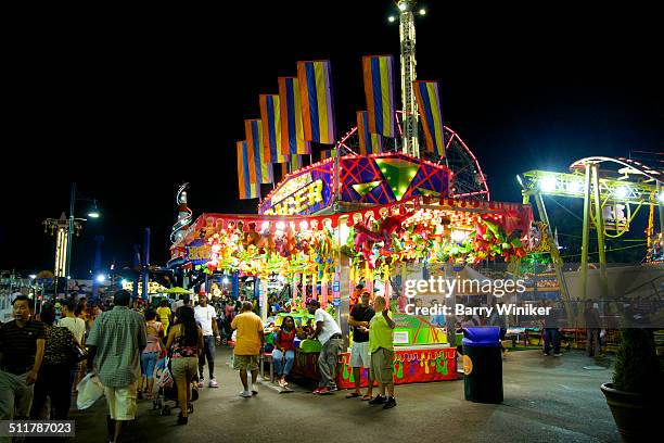 night view of people enjoying coney island - luna park coney island stock pictures, royalty-free photos & images