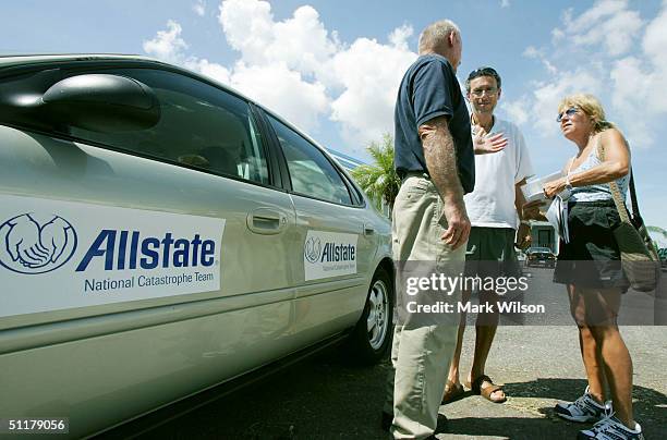 Matt and Rhoda Erza talk with an Allstate Insurance representative at a mobile office August 16, 2004 in Punta Gorda, Florida. Thousands were left...