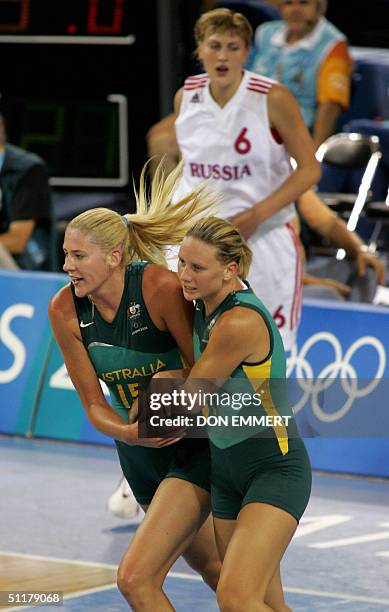 Australia's Penny Taylor and Lauren Jackson embrace in front of Russia's Natalia Vodopyanova after Taylor scored on a layup during the Olympic Games...