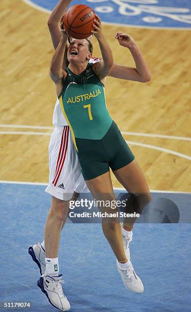 Penny Taylor of Australia goes to the basket past Elena Baranova of Russia in the women's basketball preliminary game on August 16, 2004 during the...