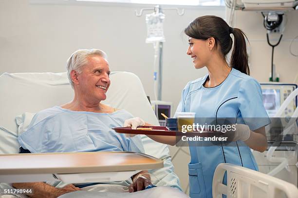 nurse serving food to patient in the hospital - hospital food stock pictures, royalty-free photos & images