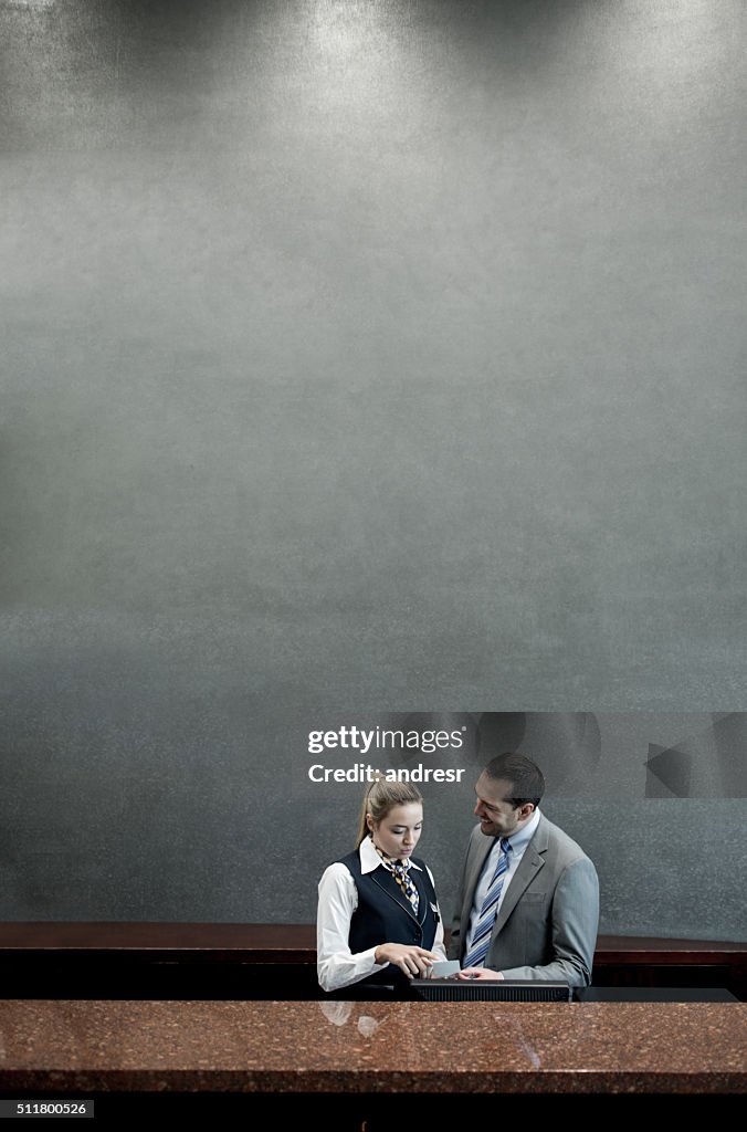 Hotel manager talking to woman in the reception
