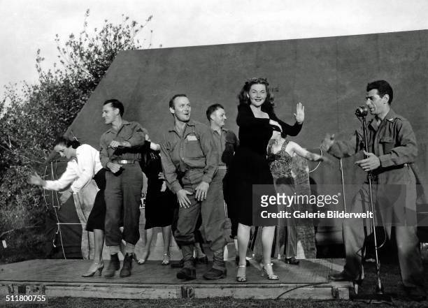 Four French actresses are dancing with American soldiers on stage. 1944. La Cambe, Normandy, France.