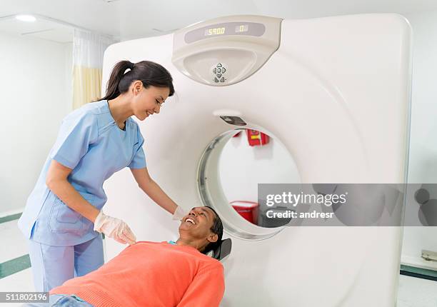 patient getting a cat scan at the hospital - cat scan machine stock pictures, royalty-free photos & images