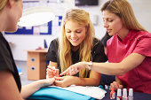 Teacher Helping Students Training To Become Beauticians