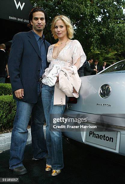 Actors Johnathon Schaech and wife Christina Applegate stand with the Volkswagon Phaeton as they arrive at the V Life's Emmy Nominee Photo Portfolio...