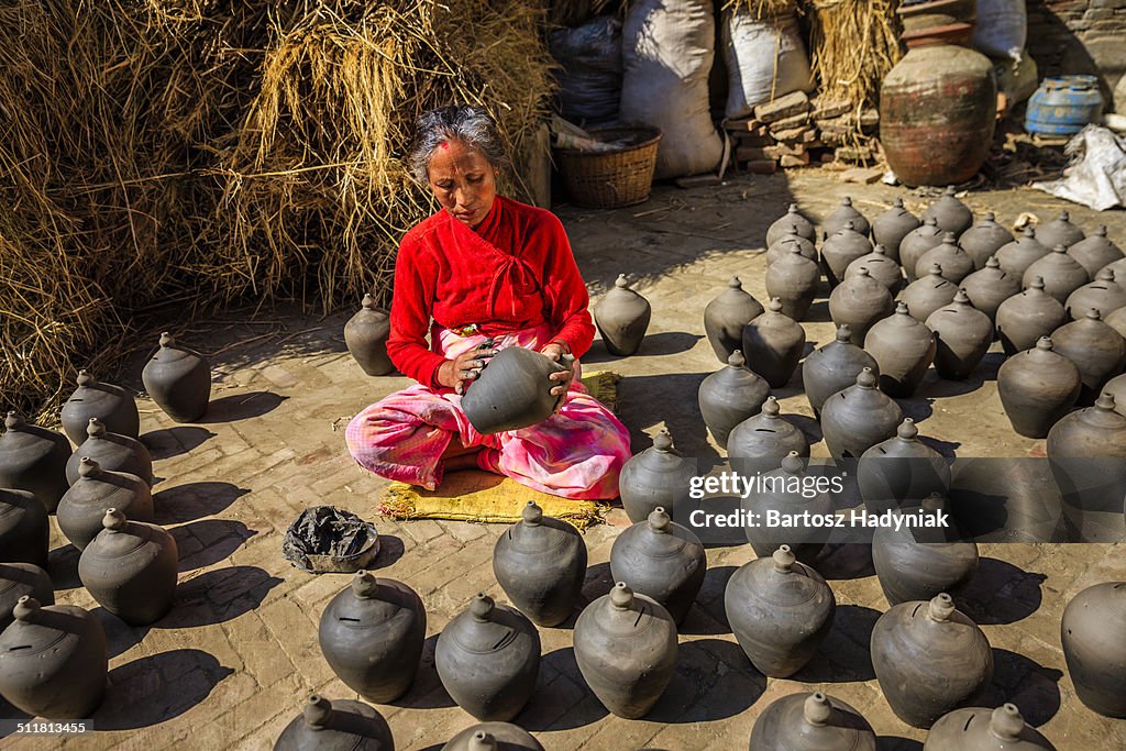 Nepali lady working on Pottery Square in Bhaktapur