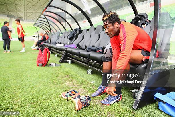 Asamoah Gyan puts his boots on during the Shanghai SIPG training session at AAMI Park on February 23, 2016 in Melbourne, Australia.