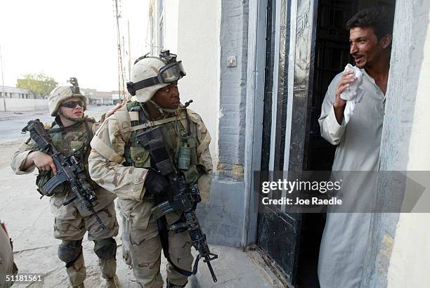 American army Sergeant Terrance Batts from the 1st Cavalry Division 2nd Battalion 7th Cavalry checks on a resident who wanted to leave the area of...