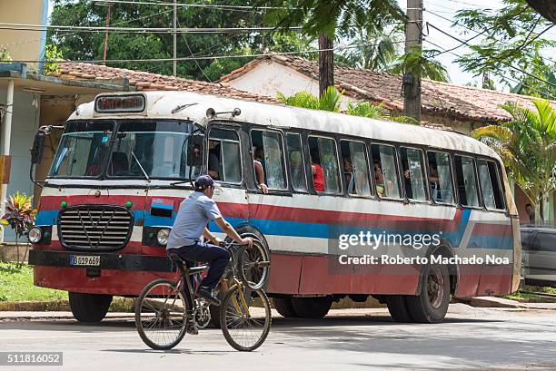 Old Bus Riders old vintage bus and man riding a bicycle. Cycle riding on a road and ...