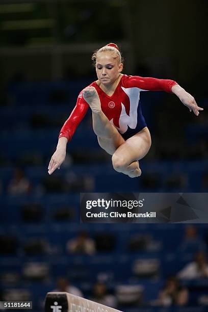 Courtney McCool of the USA performs on the balance beam in the qualification round of the team event at the women's artistic gymnastics competition...
