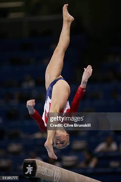 Courtney McCool of the USA performs on the balance beam in the qualification round of the team event at the women's artistic gymnastics competition...