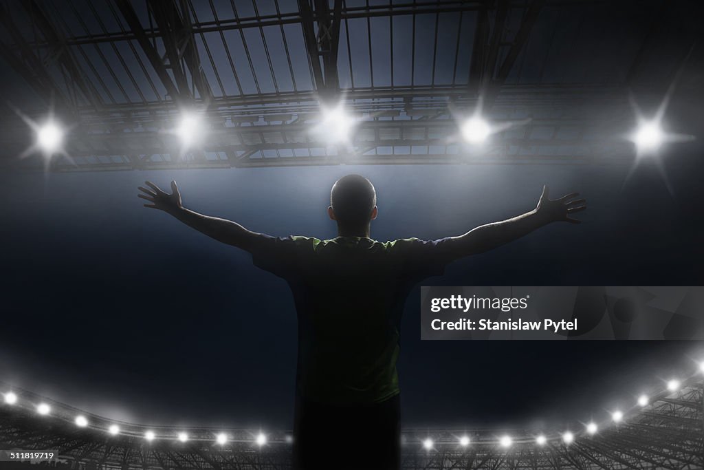 Soccer player celebrating victory in stadium