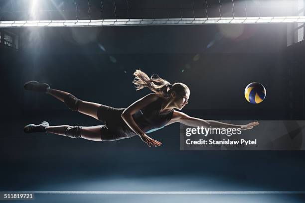 volleyball player jumping to the ball - volleyball netz stock-fotos und bilder