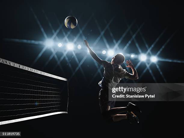 volleyball player jumping to the ball - volleyball stock-fotos und bilder