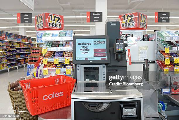 Shopping basket is arranged for a photograph next to a self checkout counter in a Coles supermarket, operated by Wesfarmers Ltd., in Melbourne,...