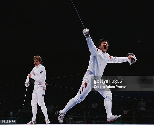 Lei Wang of China celebrates his victory over Pavel Kolobkov of Russia in the men's fencing individual epee semifinal on August 17, 2004 during the...