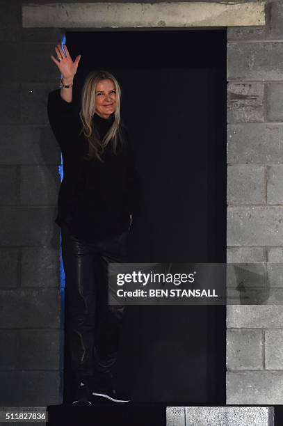 British designer Amanda Wakeley waves at the end of her catwalk show at the Autumn / Winter 2016 London Fashion Week in London on February 23, 2016....