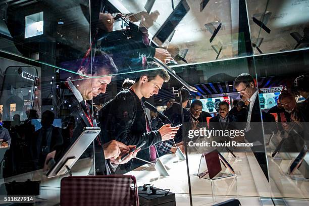 Visitors check HTC mobile phones on the second day of the event at the Fira Gran Via Complex on day 2 of the Mobile World Congress on February 23,...