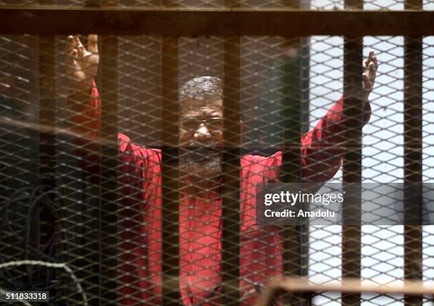 Egypts ousted President Mohamed Morsi is seen behind the bars during his trial on charges of espionage on behalf of Qatar at the Police Academy in...