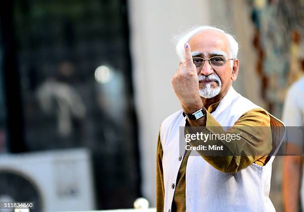 Vice President Hamid Ansari shows his ink-marked finger after casting his vote for general election of the 16th Lok Sabha 2014 on April 10, 2014 in...