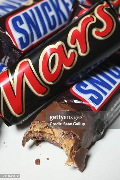 In this photo illustration Snickers and Mars chocolate bars lie on a table on February 23, 2016 in Berlin, Germany. The Mars company, which owns both...