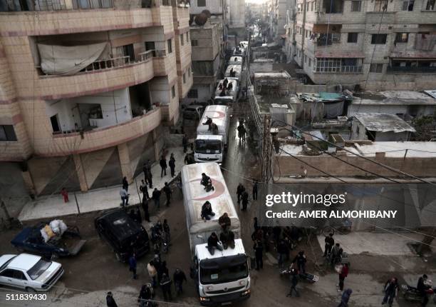 Red Crescent convoy carrying humanitarian aid arrives in Kafr Batna, in the rebel-held Eastern Ghouta area, on the outskirts of the capital Damascus...